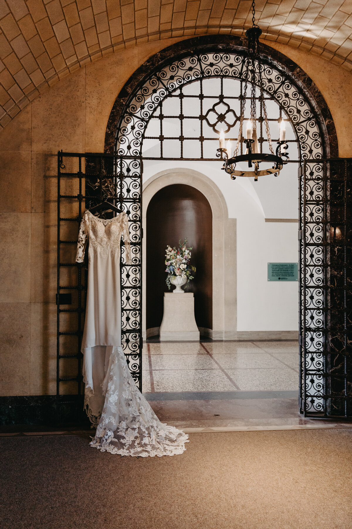long lacey dress hanging off of archway indoors with victorian vintage cathedral vibes