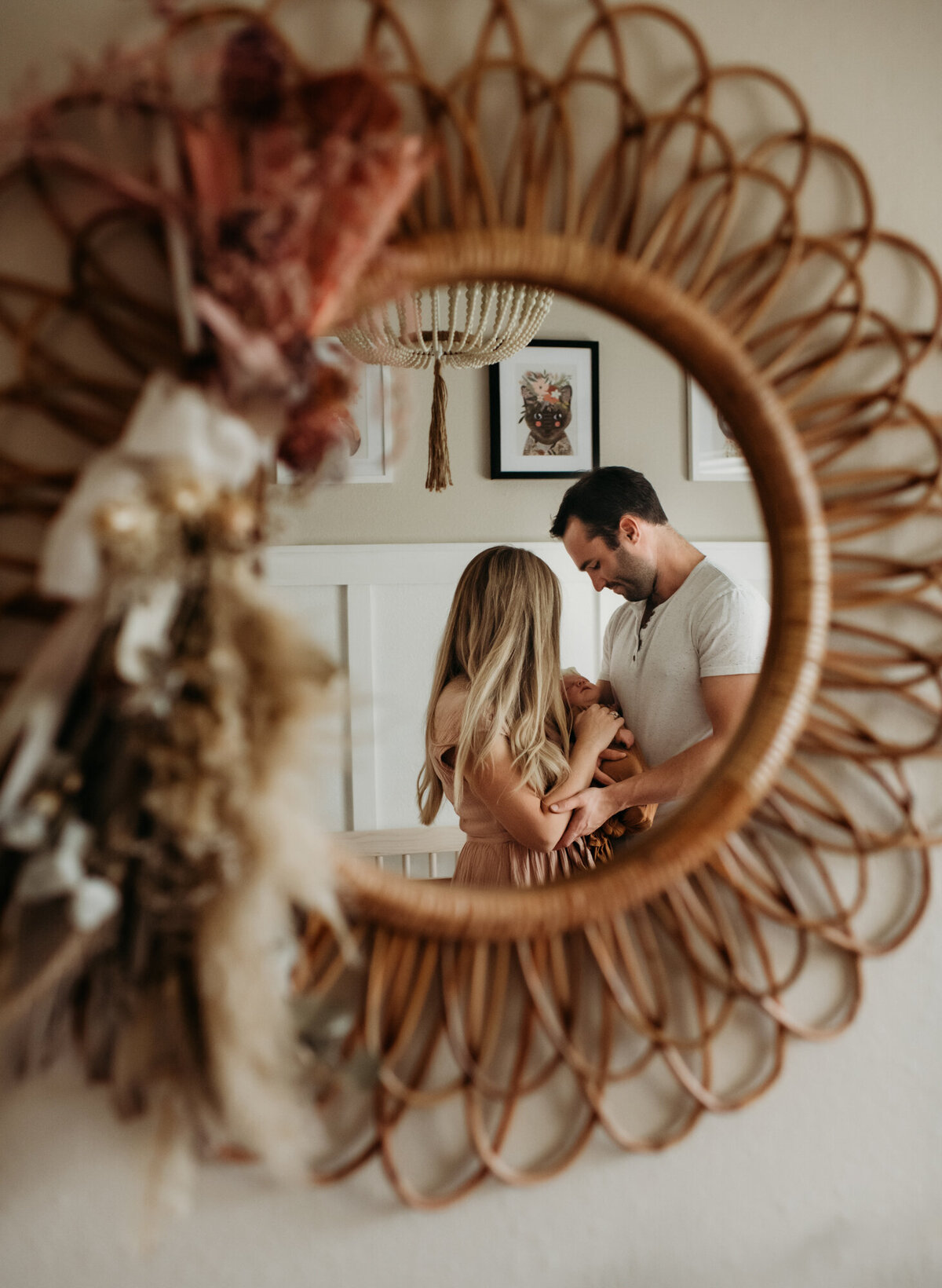 Newborn Photographer, Mom and dad snuggling their new baby in the mirror.