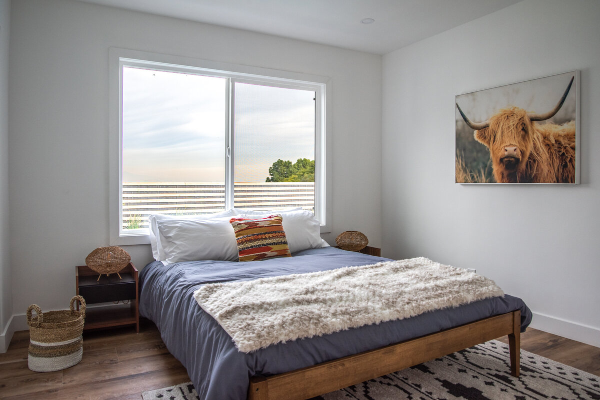 contemporary-guest-bedroom-with-large-window-and-midcentury-decor-aw-development