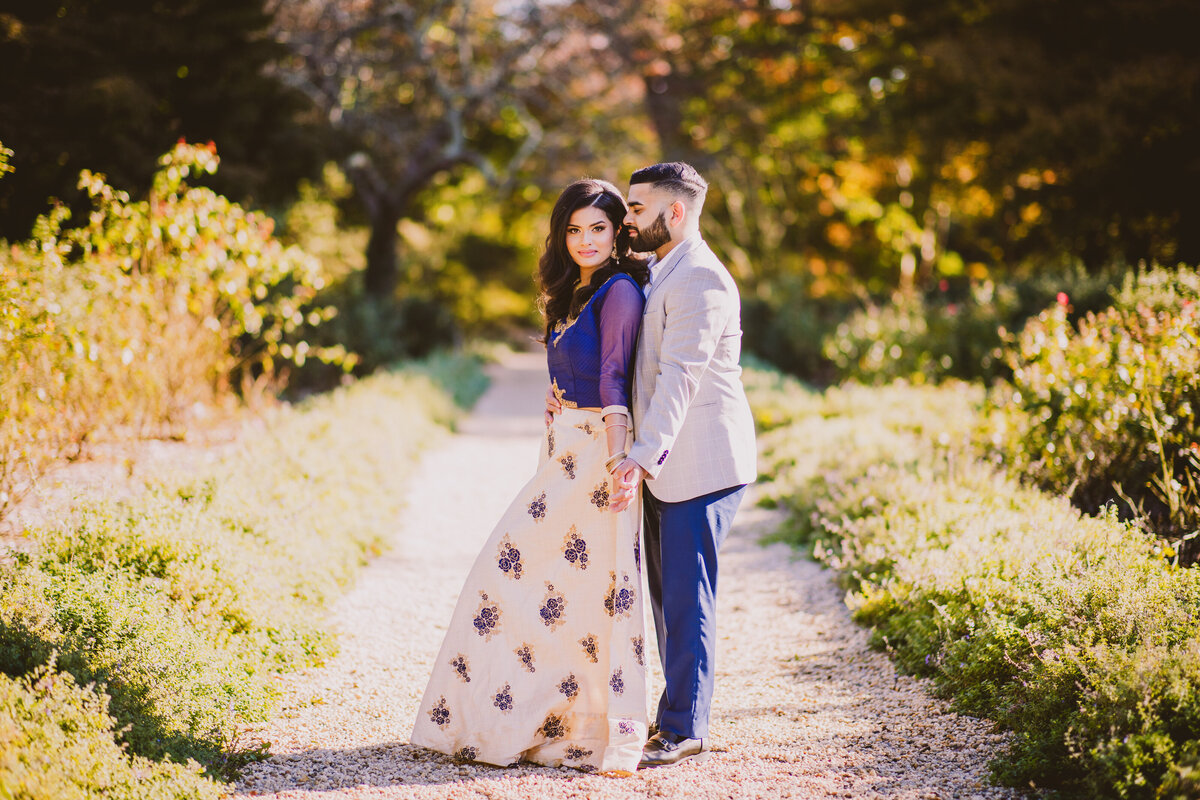A couple sharing a moment at the planting fields arboretum garden in oyster bay ny