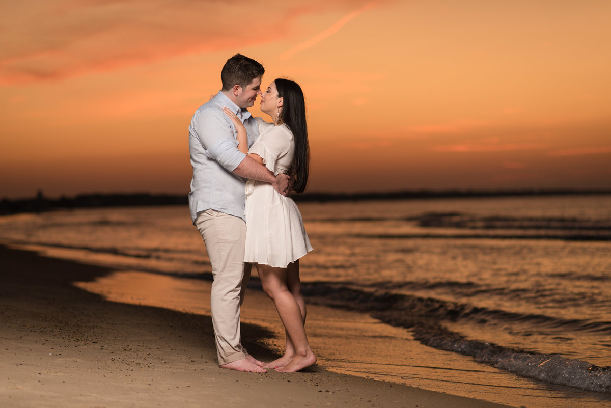 engaged couple at sunset at virginia beach