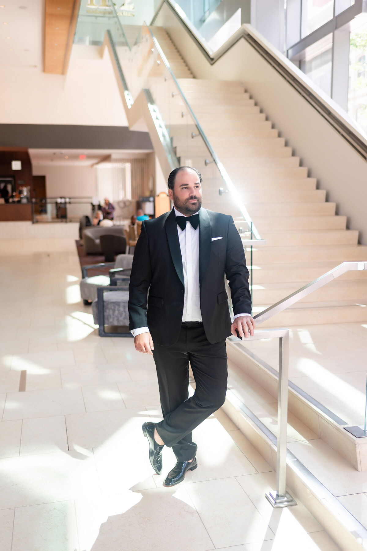 groom waiting for bride at the bottom of the staircase at the fairmont hotel pittsburgh