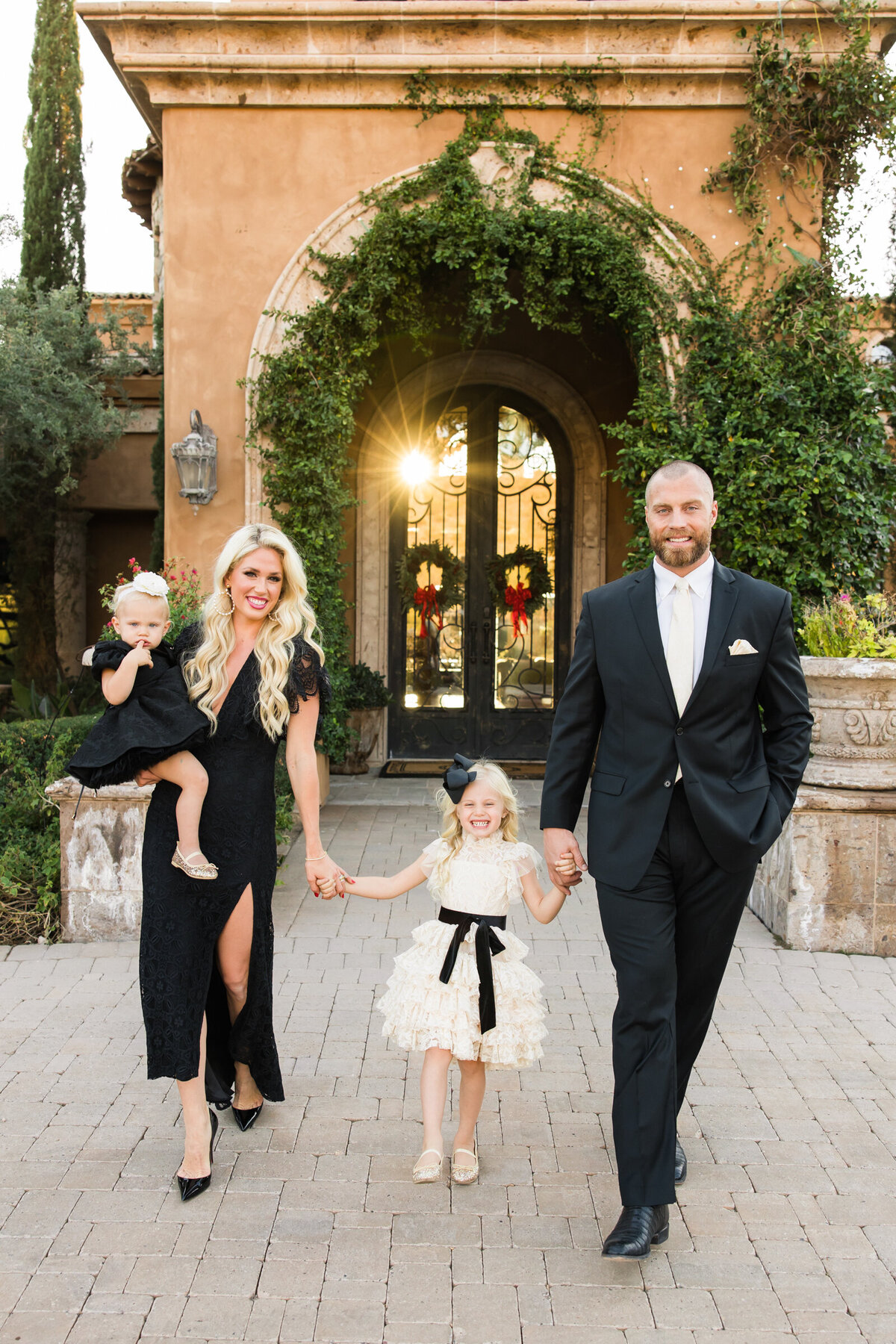 family walking in front of their house for photo