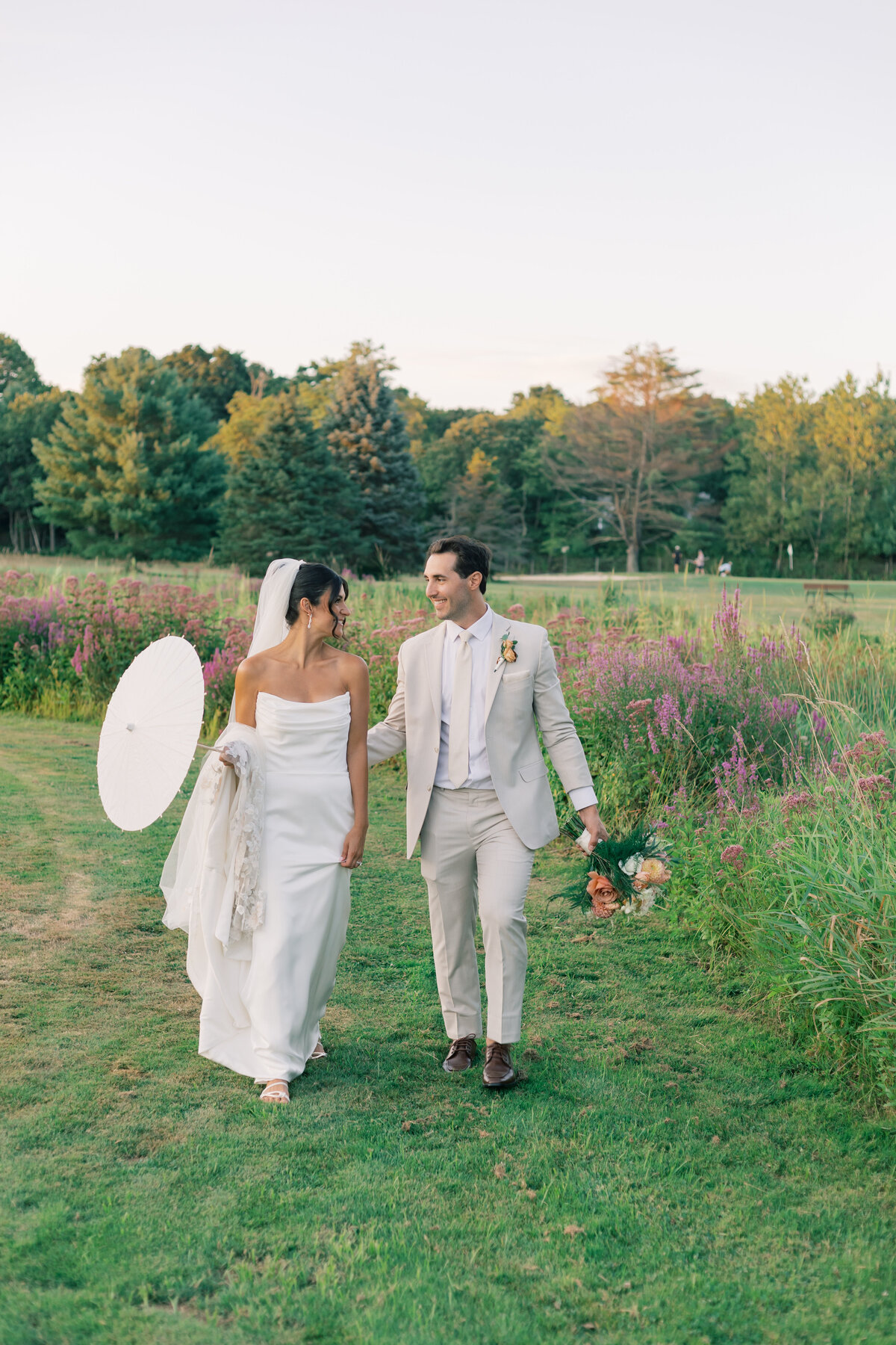 Bride and Groom walking through golf course in Massachusetts