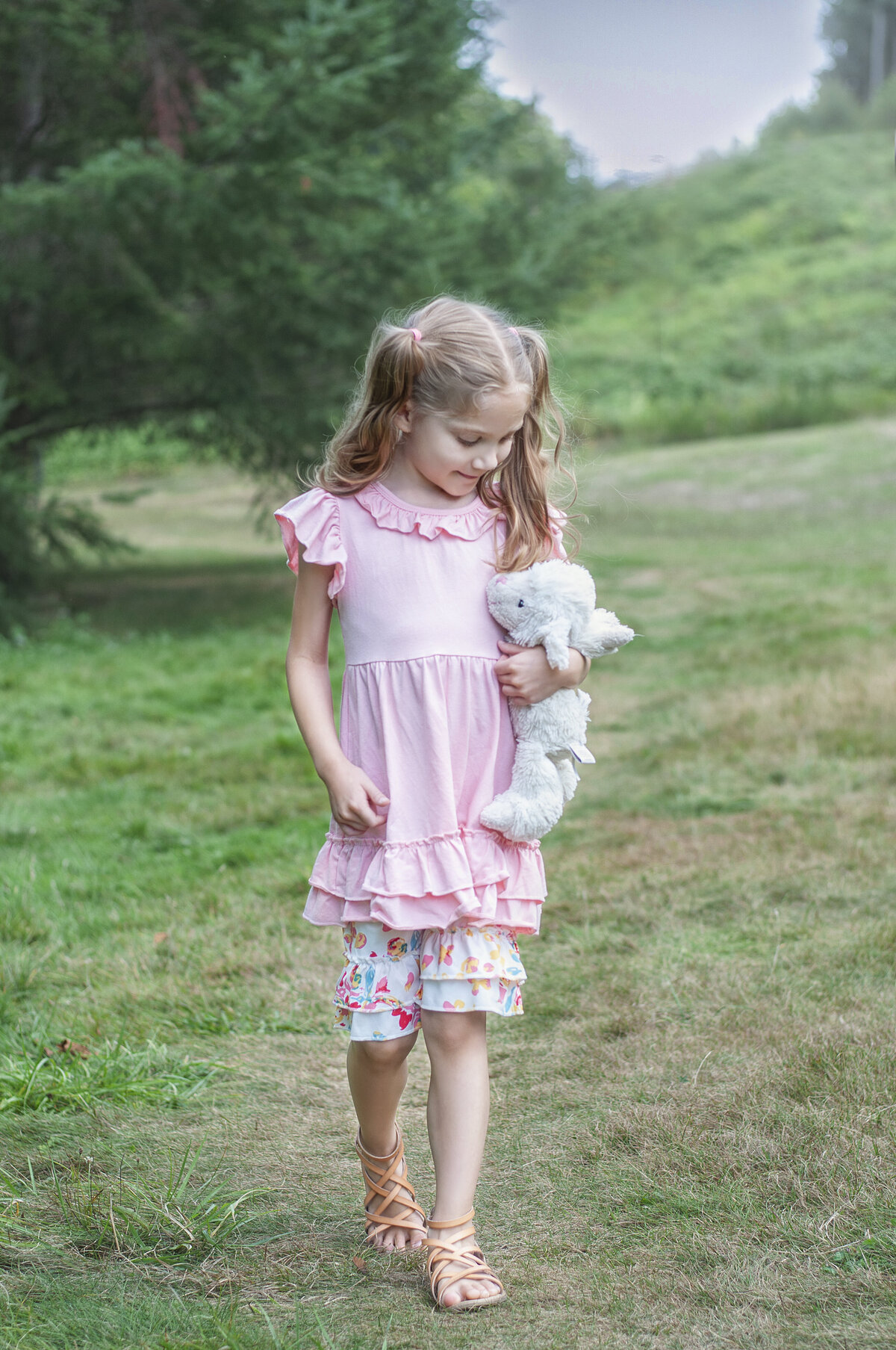 Girl walking with stuffed lamb