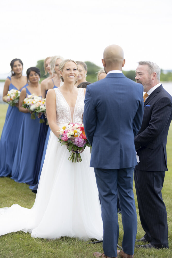 bride smiling at her groom during wedding ceremony - gold shoes and wedding details - branford house wedding