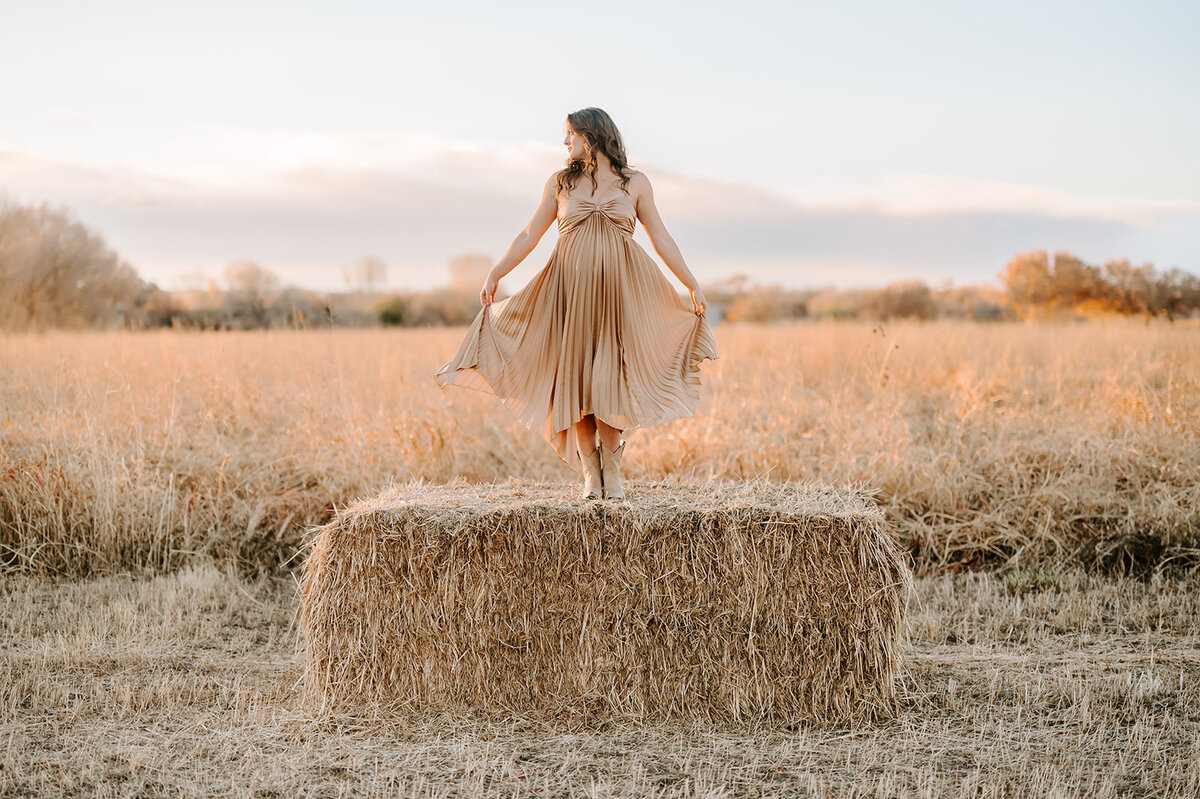 woman in a field twirling in dress