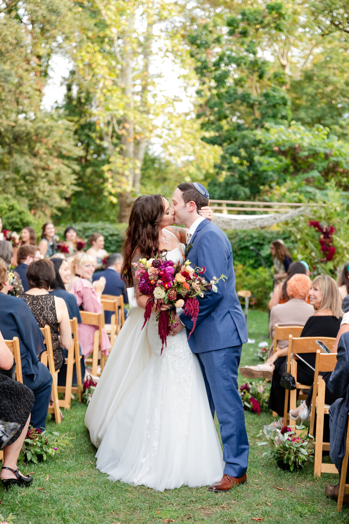Bride and groom kissing after Jewish wedding ceremony