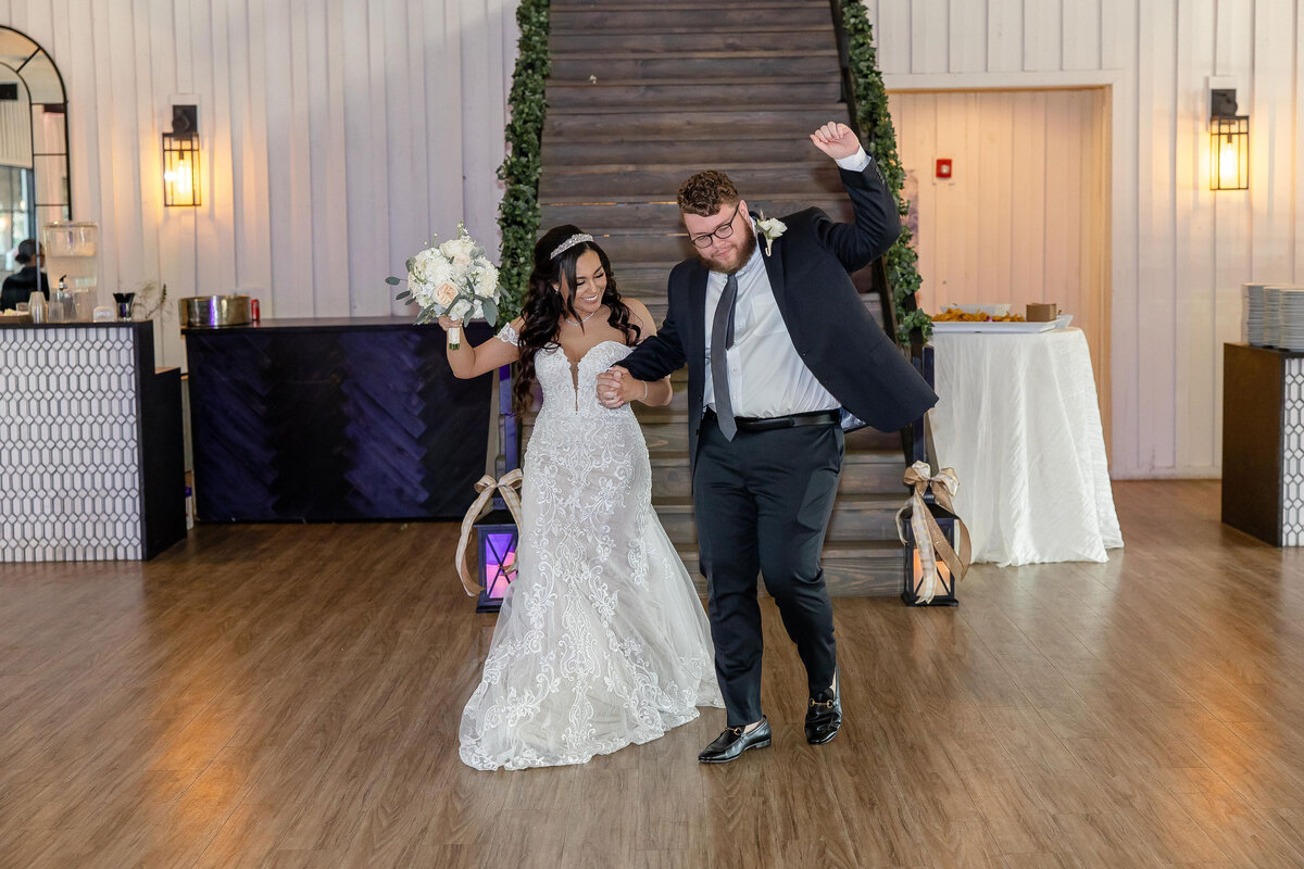 bride and groom dance as they descend staircase at Milestone New Braunfels