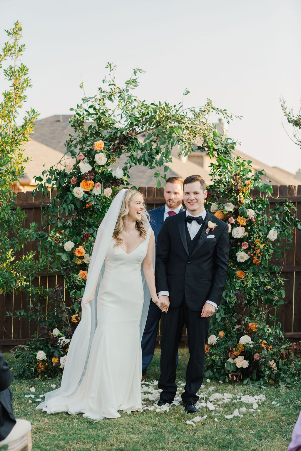 Wedding ceremony with floral arch by Vella Nest Florals