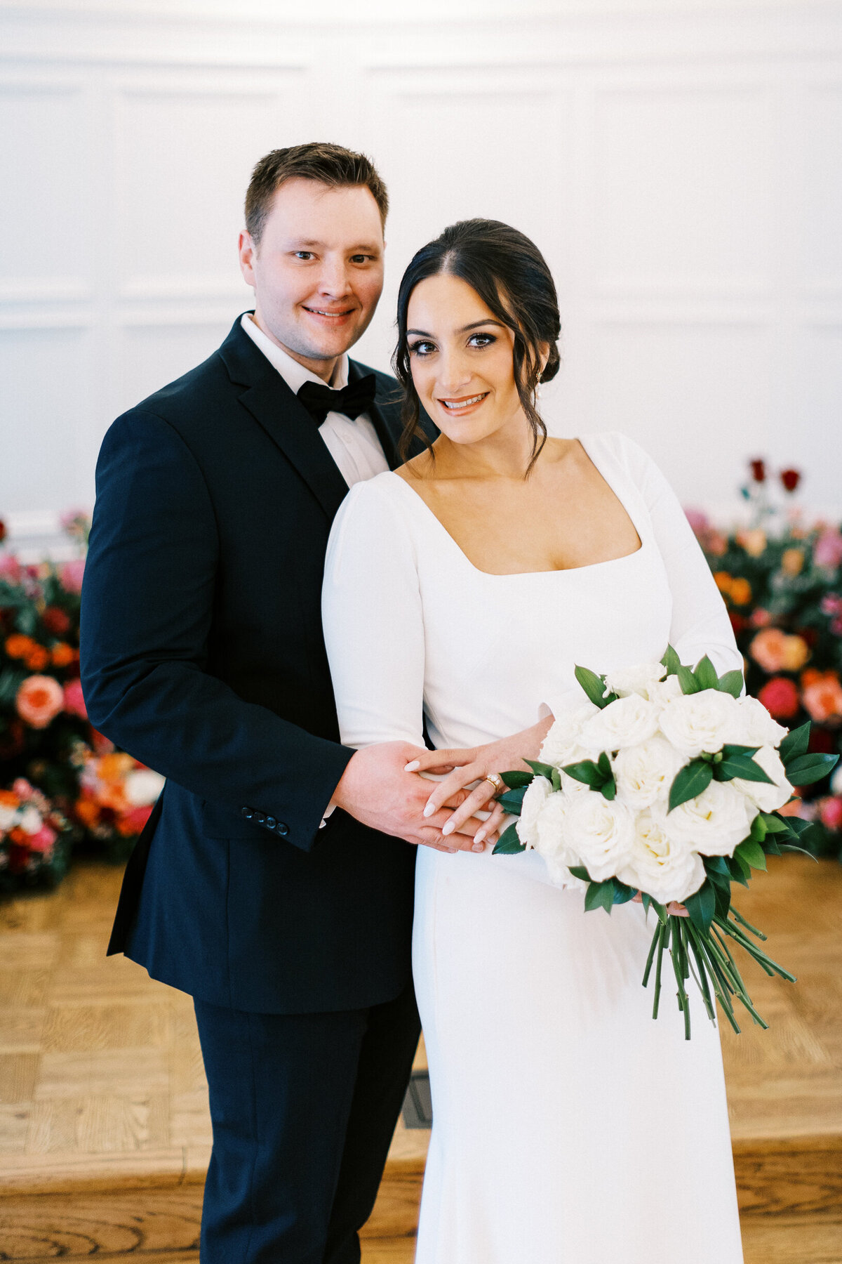 Bride and groom posing for a classic portrait for Toly Dzyuba Photography.