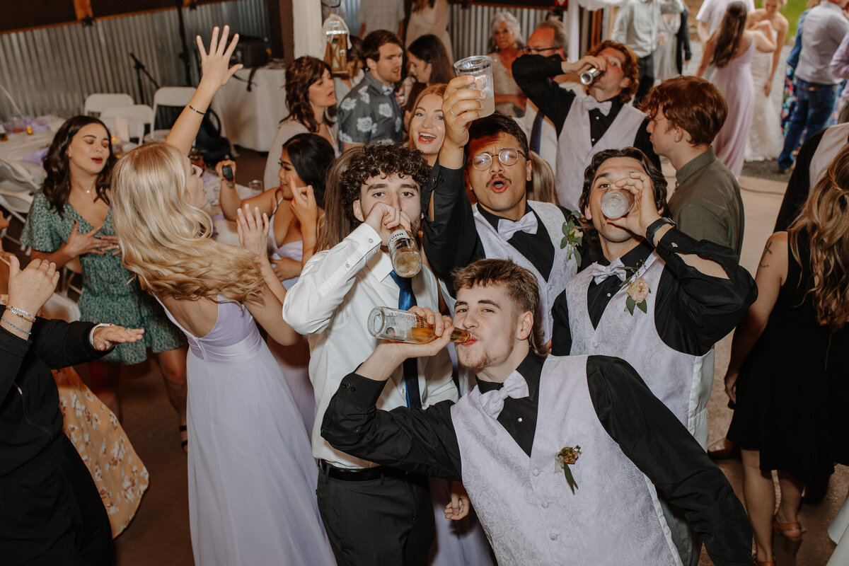 Crowd of young people drinking and dancing at wedding