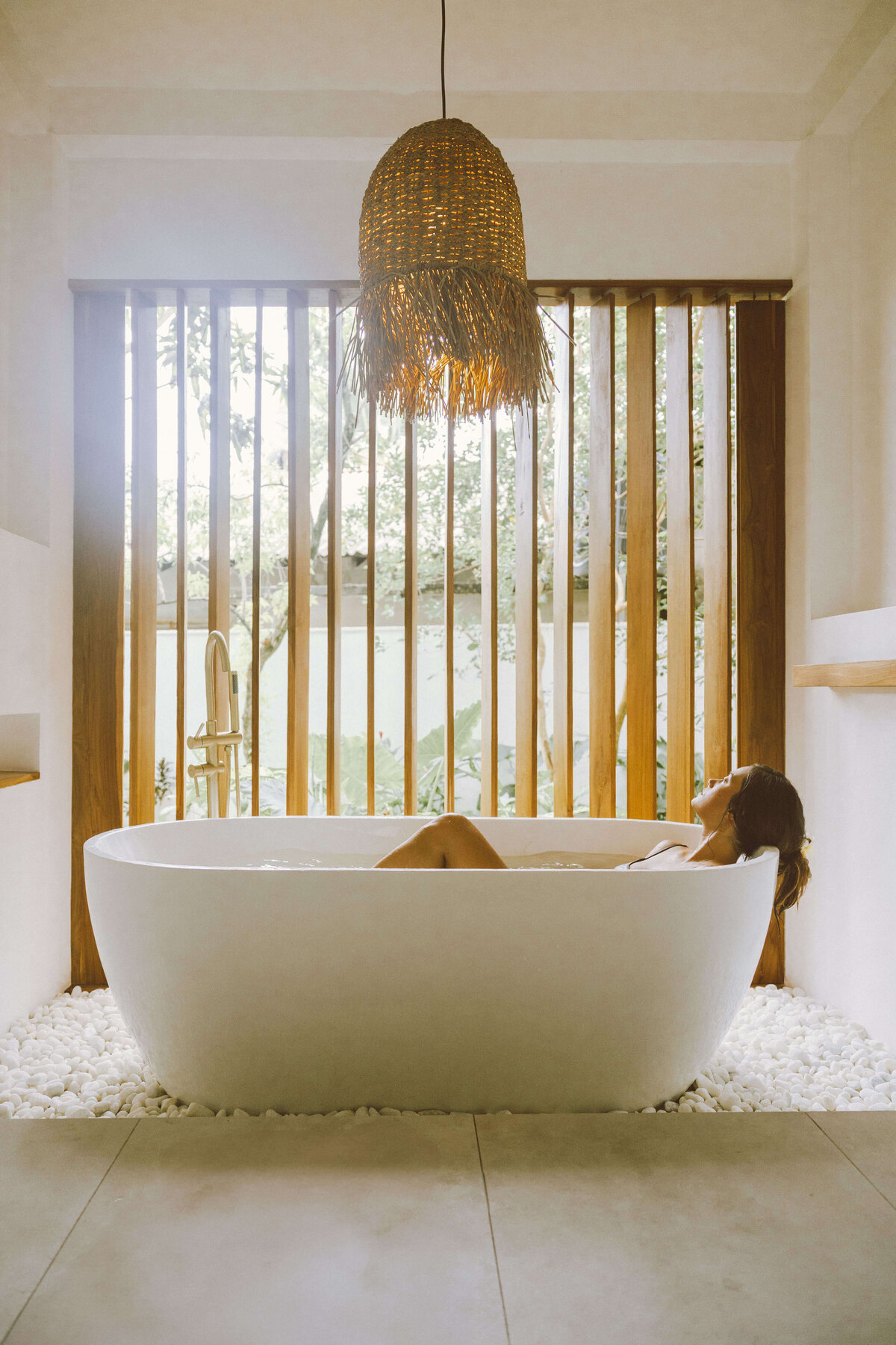 Skin care brand photography in spa-like bathroom setting with bathtub
