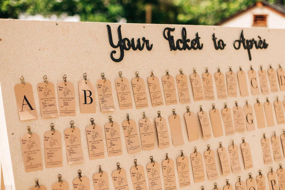 A large seating chart at an outdoor wedding.
