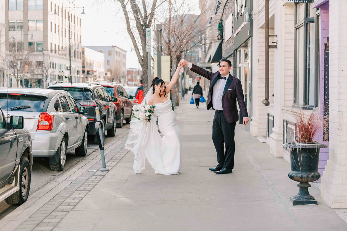 Bride and groom dance on 2nd ave  in Saskatoon.