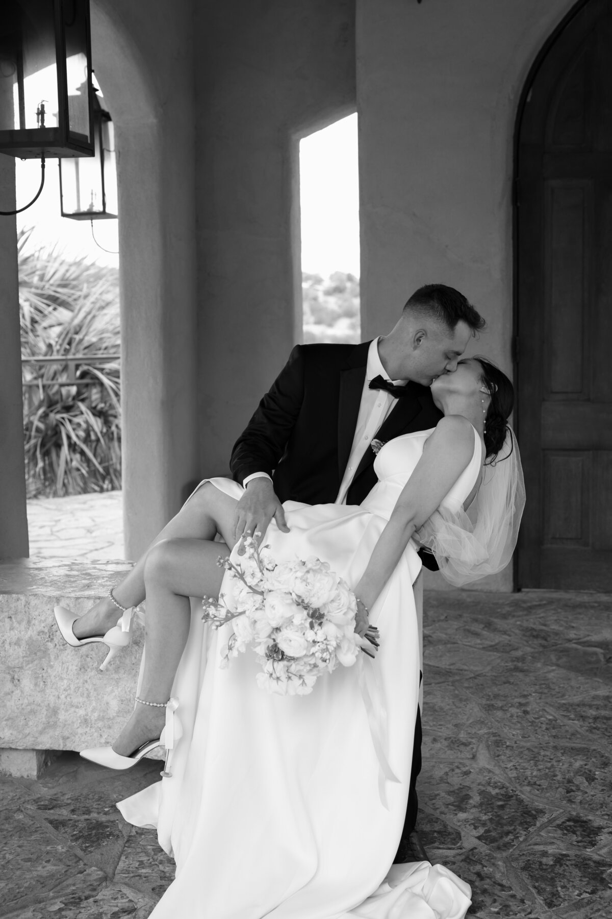 wedding photographer in austin takes photo of bride and groom kissing