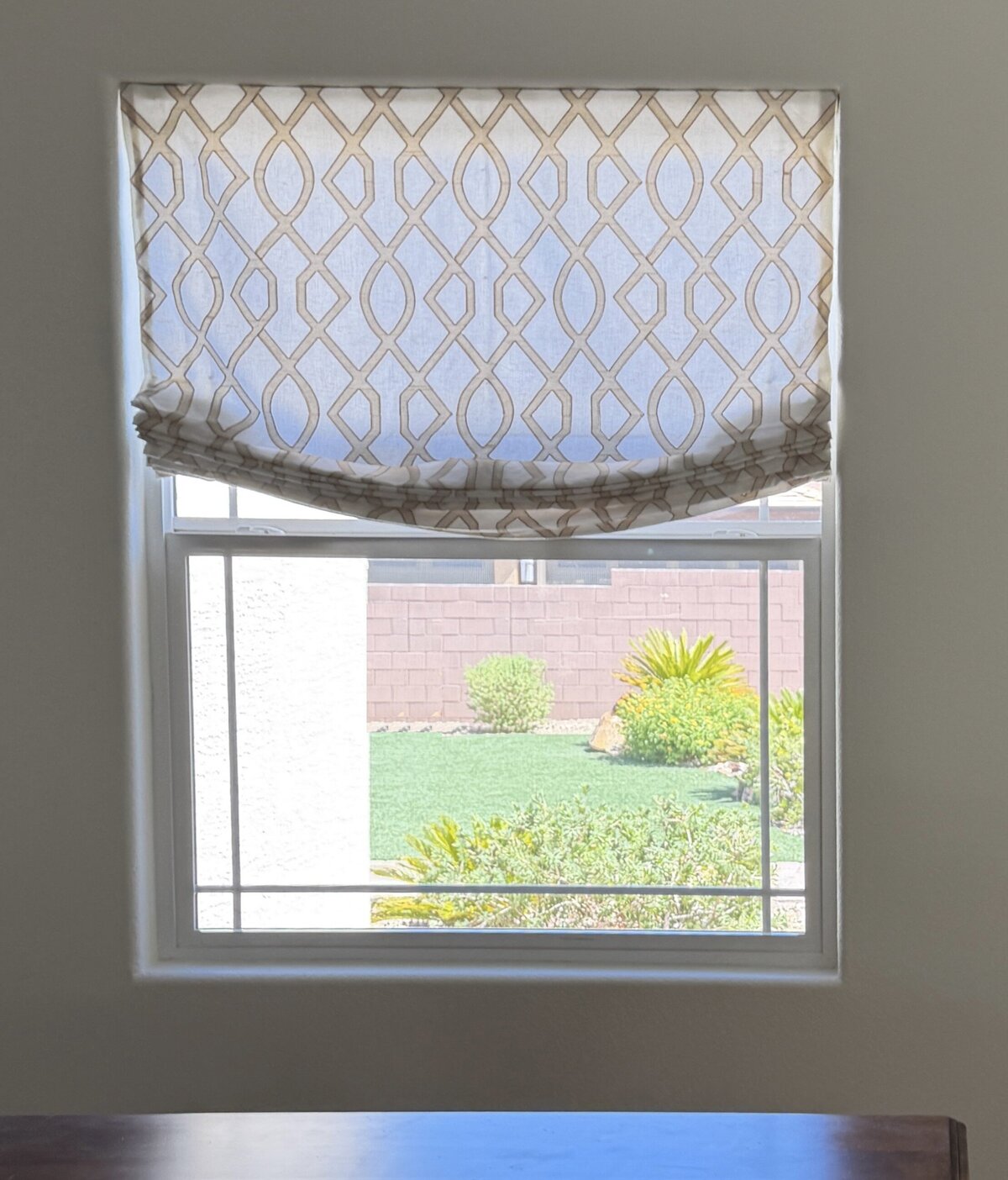 Relaxed Roman shade in a geometric patterned fabric on a Las Vegas dining room window