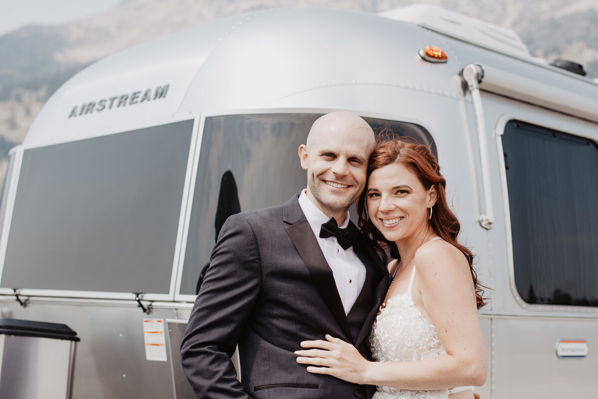 Jackson Hole photographers capture bride and groom smiling in wedding attire