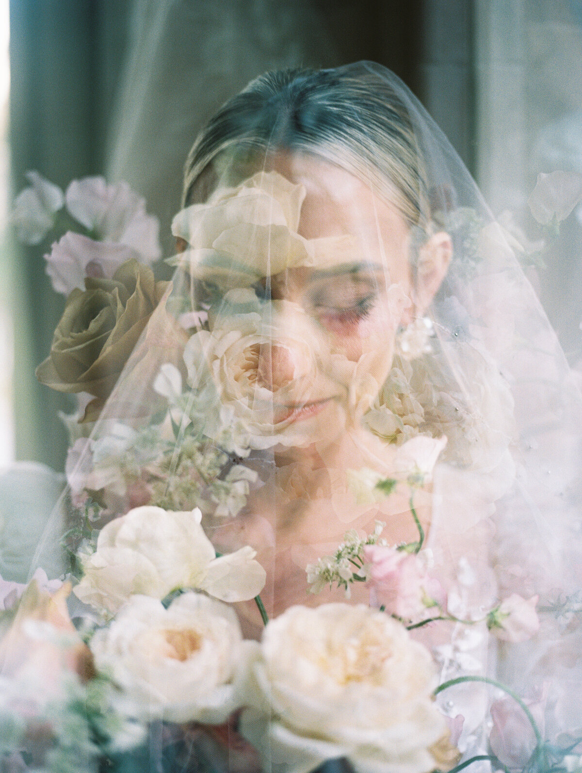 bride with veil in chateau before wedding ceremony with flowers