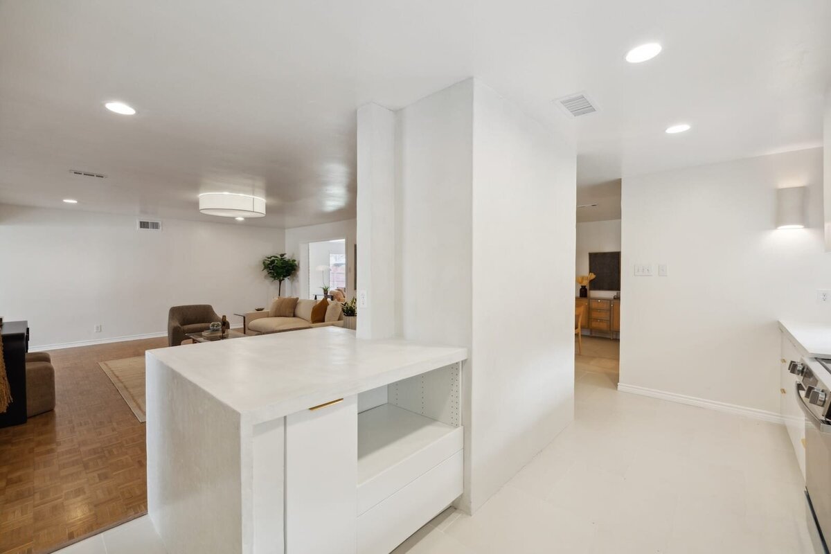Modern kitchen pass-through at 3120 Chapel Downs Dr Dallas TX with white countertops, open view into living and dining area — listed by Haven Realty Group.