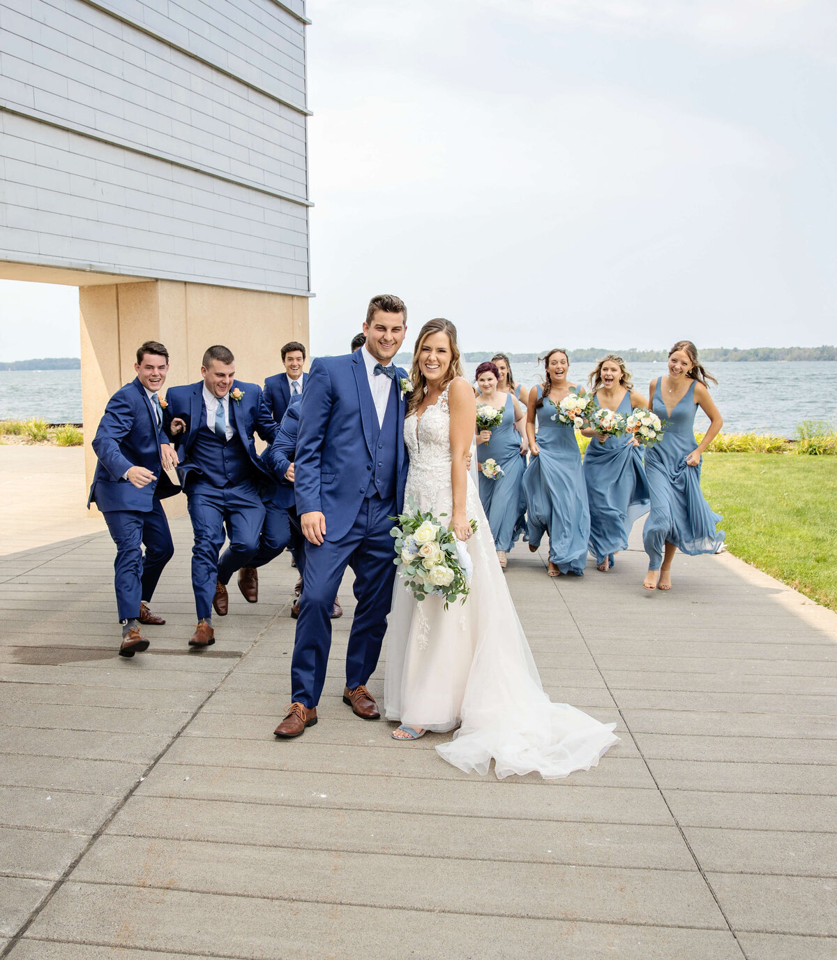 Photo of bride and groom posing with wedding party on the Erie Pa bayfront