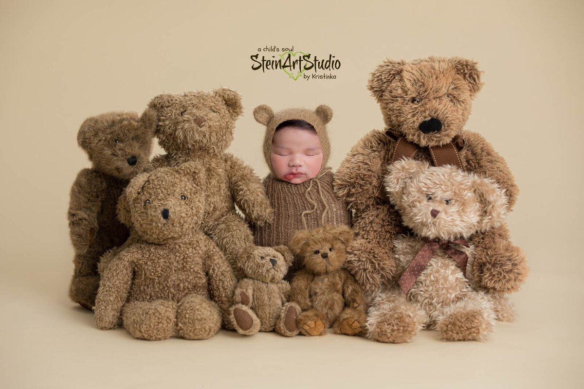 Newborn wrapped in brown blanket for photography with stuffed bears