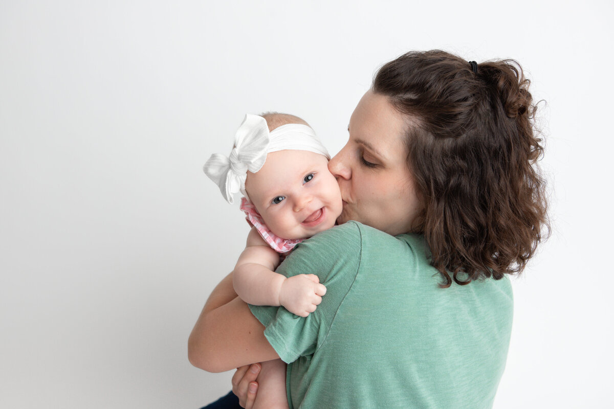 Edmonton mom and baby pose with white studio backdrop