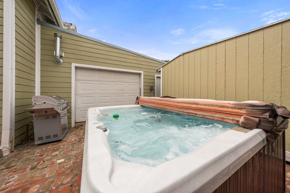 Jacuzzi hot tub in the backyard of this five-bedroom, 4-bathroom pet-friendly vacation rental house for 12 guests with free wifi, free parking, hot tub, mother-in-law suite, King beds and updated kitchen in downtown Waco, TX.