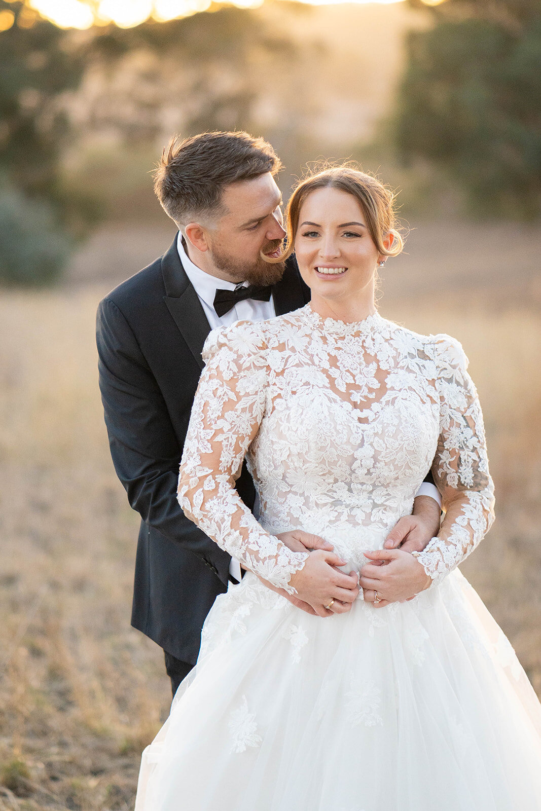 Candid wedding photo of a couple at sunset