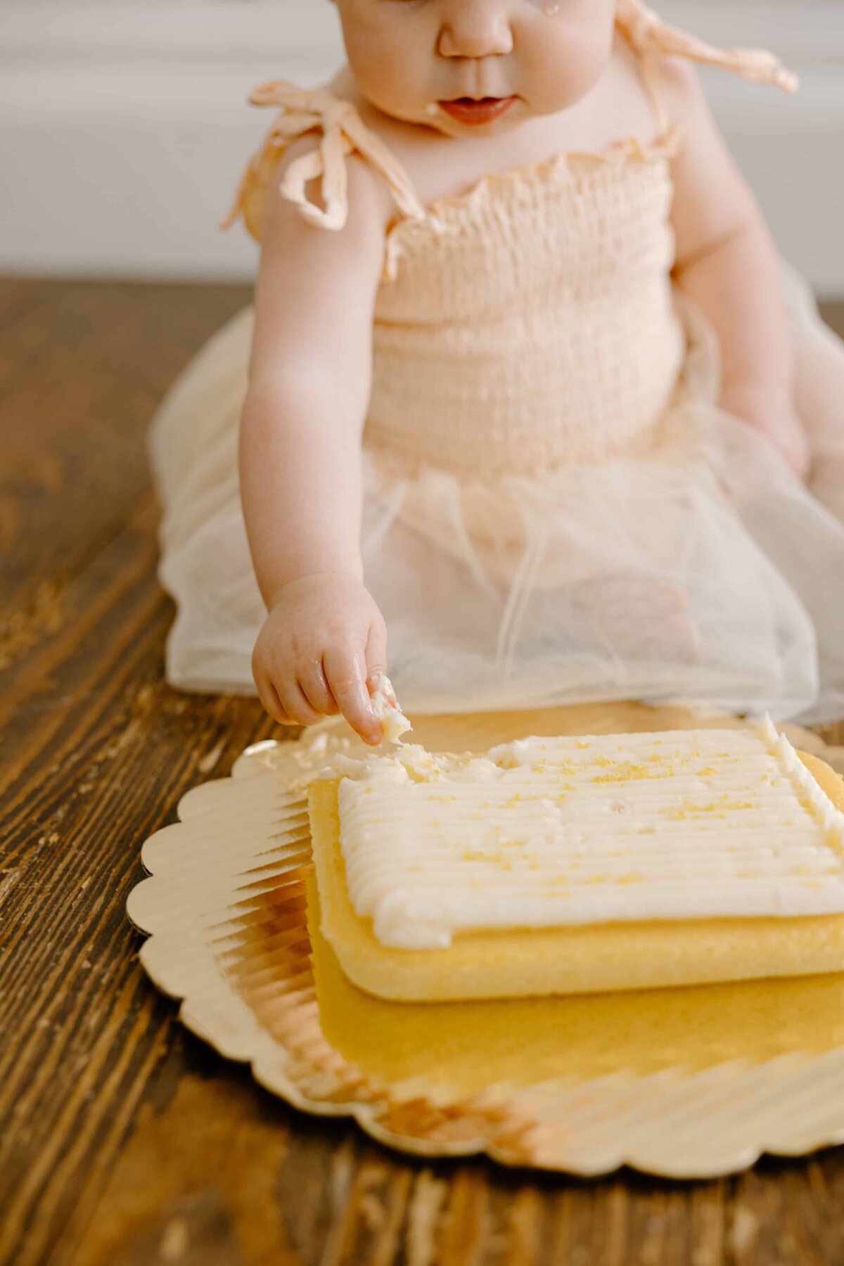 A baby eats cake for their first birthday.