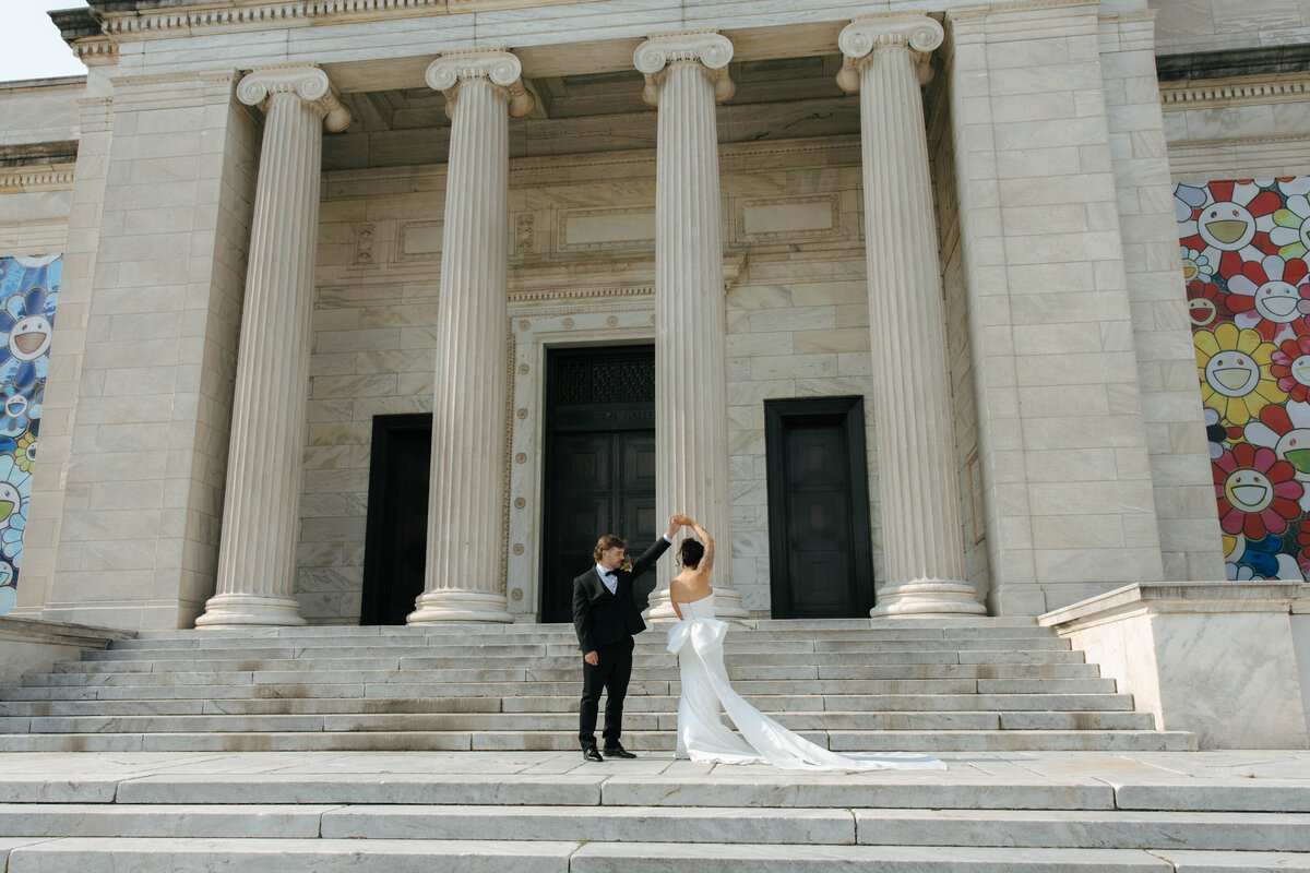 Wedding couple taking their sunset couples photos at the Cleveland Museum of Arts by April Graber Photography