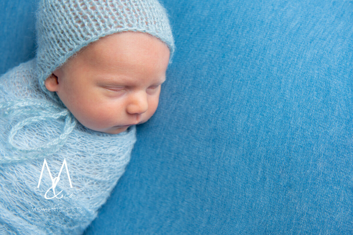 Newborn-Baby-Boy-Wrapped-in-Blue-in-Bonnet-2
