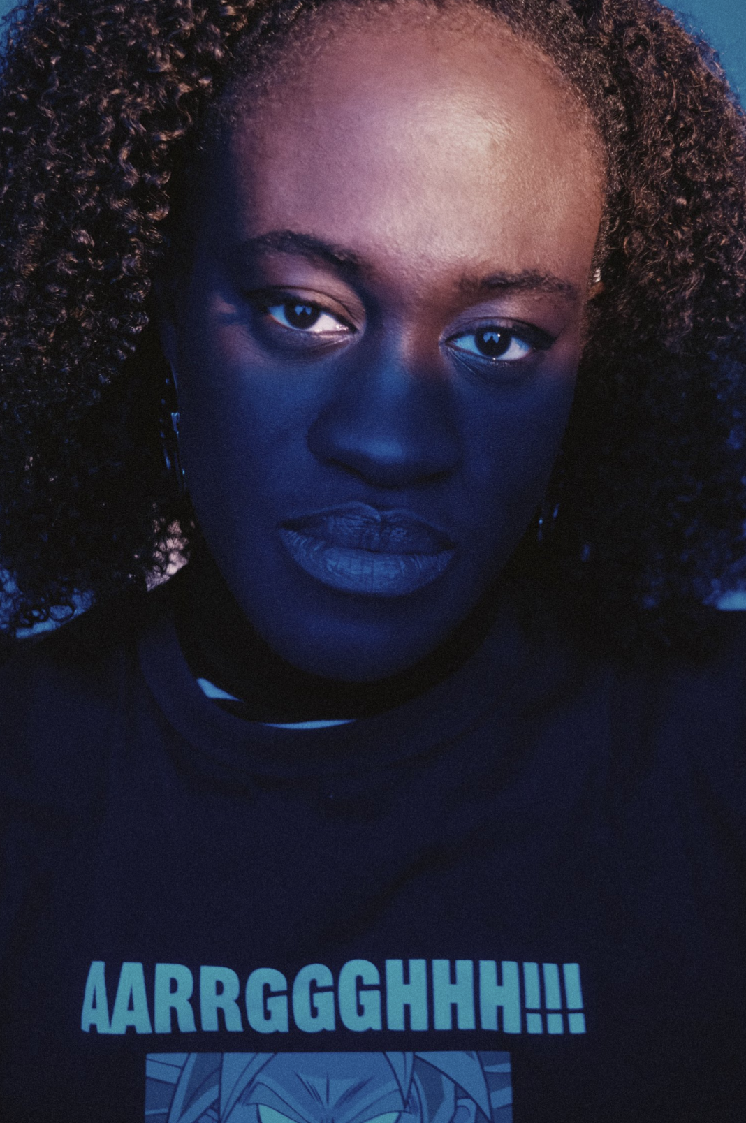 A character shot through glass, evoking isolation and intimacy.