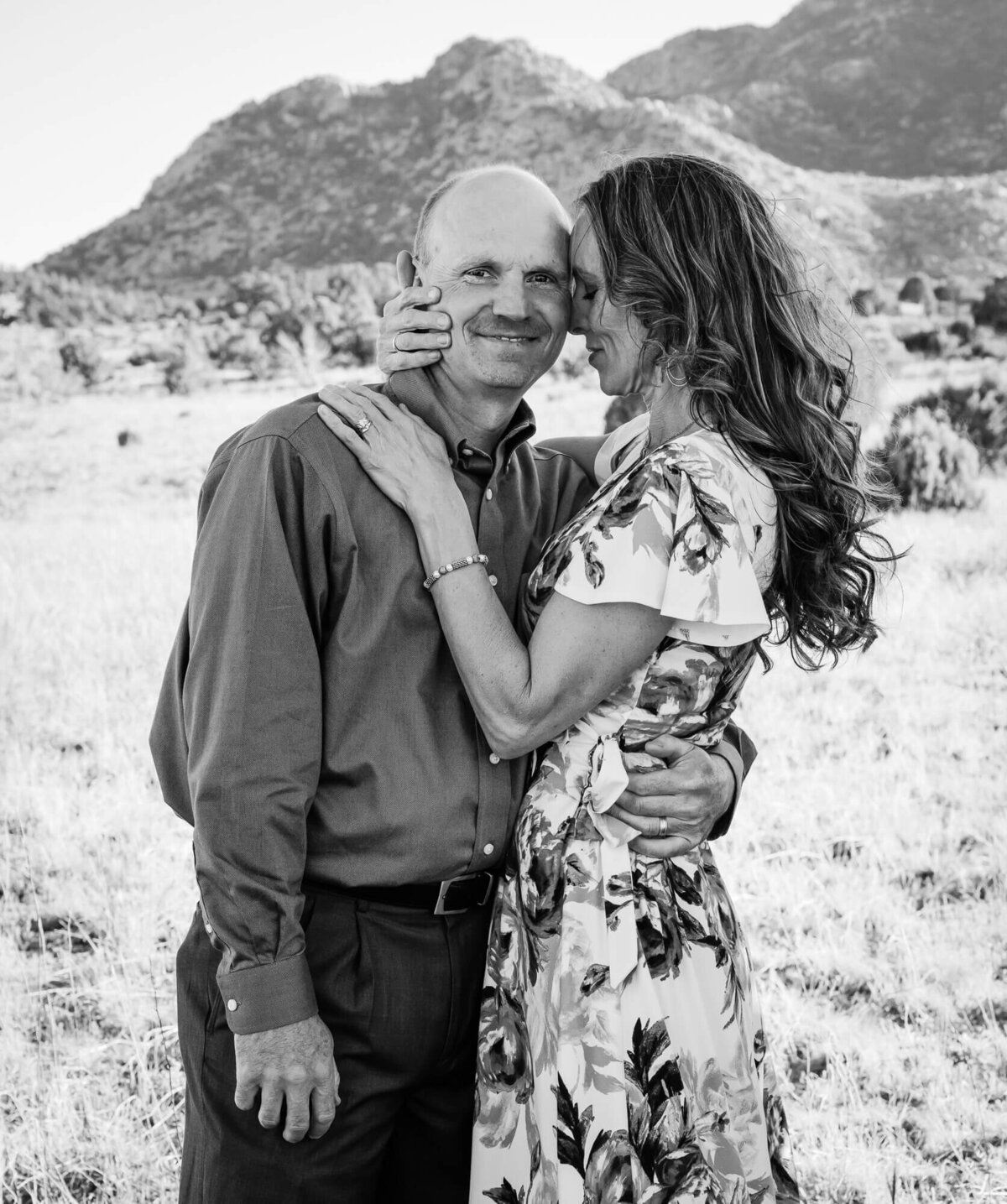 Couple poses in front of Granite Mountain in Prescott family photos with Melissa Byrne