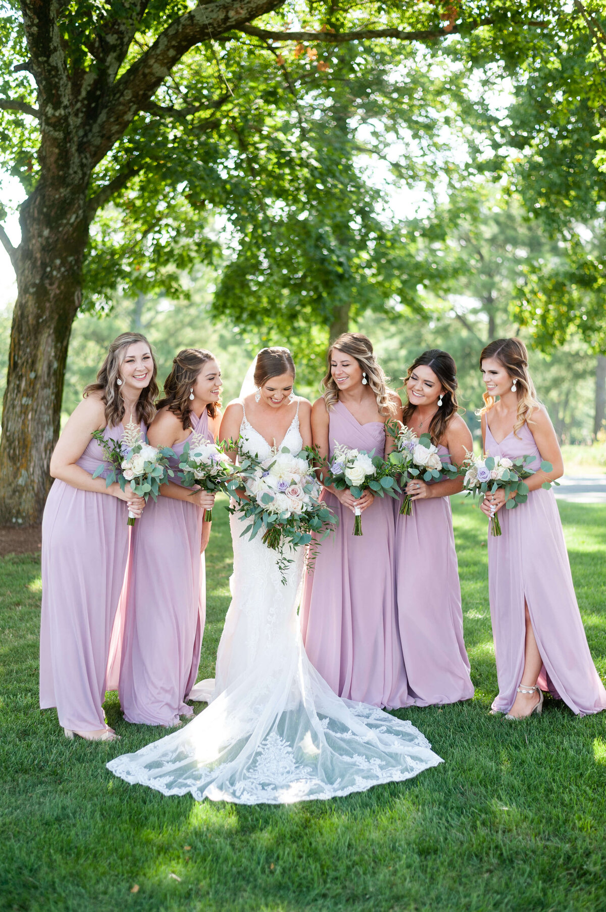 bride with bridesmaids wearing lilac dresses at wedding at Stones River Country Club