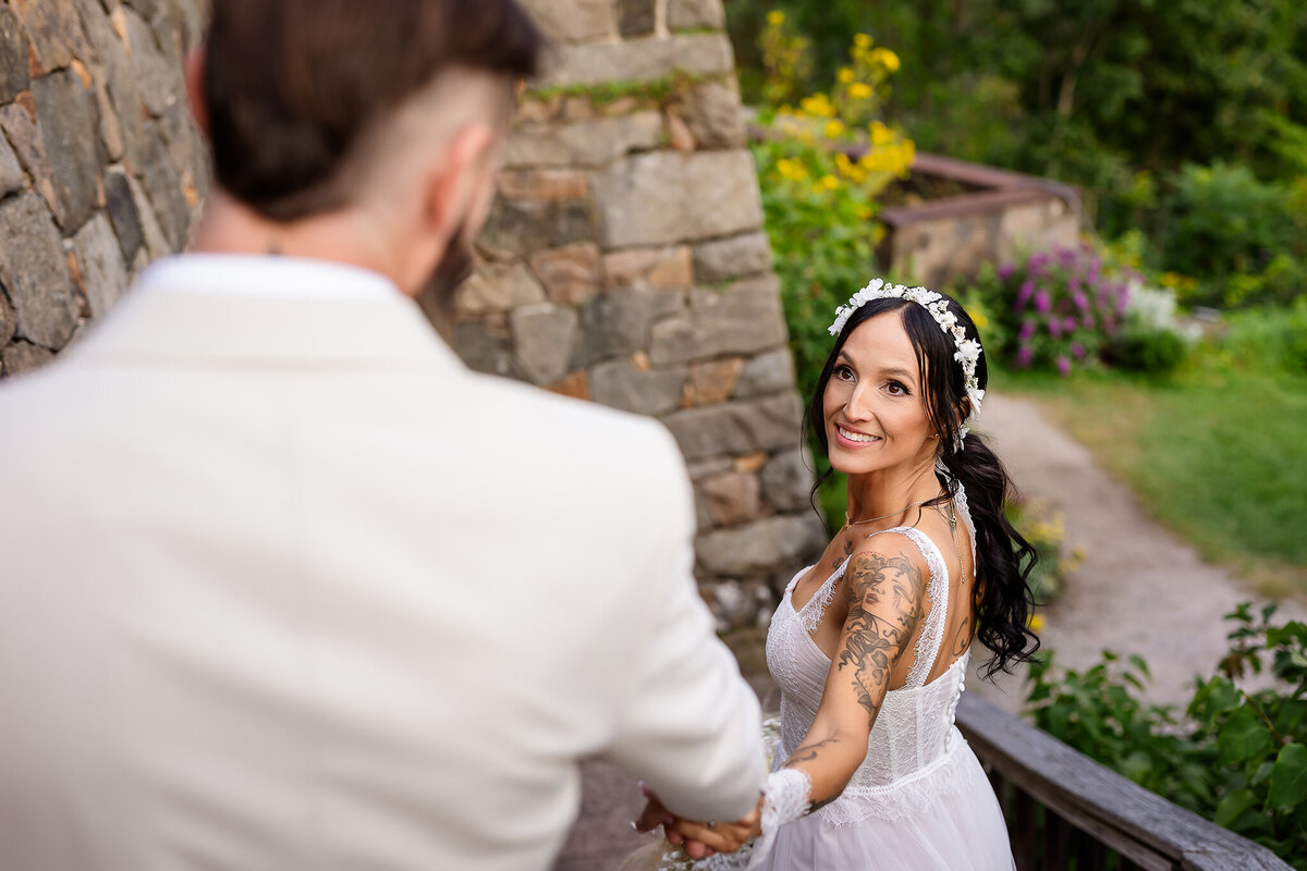 Bride leading groom down stairs at Castle in the Clouds by NH Wedding Photographer