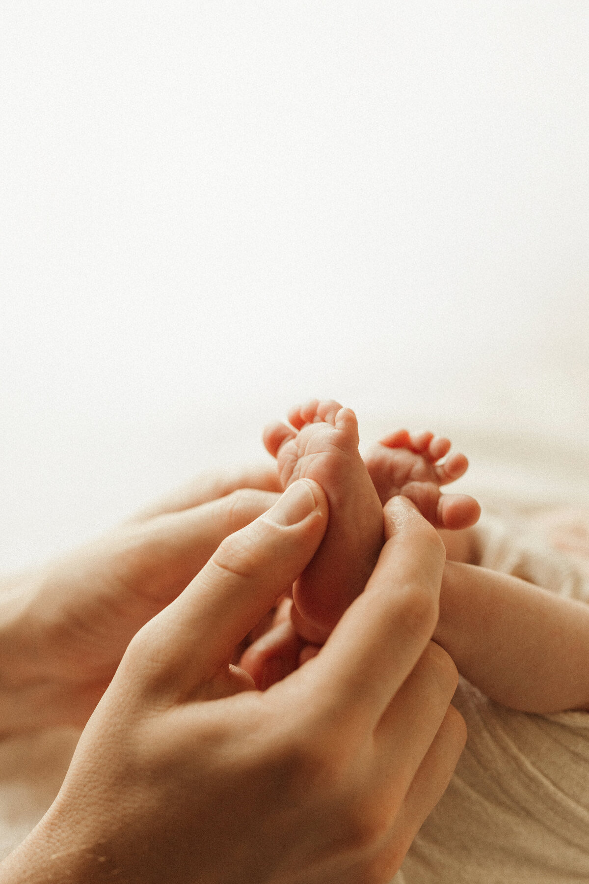 Parents holding newborn in cozy Nashville home during lifestyle photography session