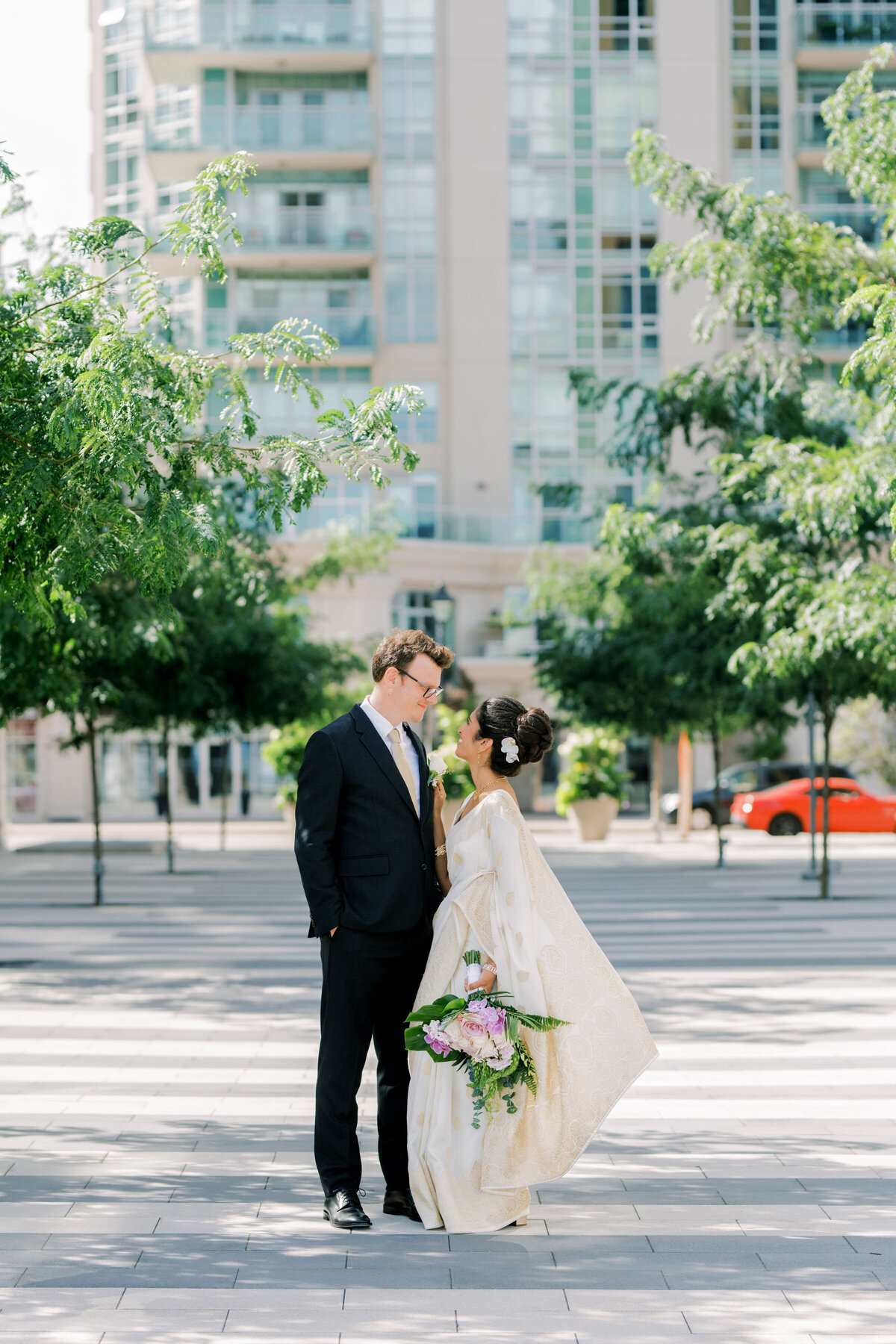 bride and groom sharing a moment together outside in the courtyard at the pearle hotel
