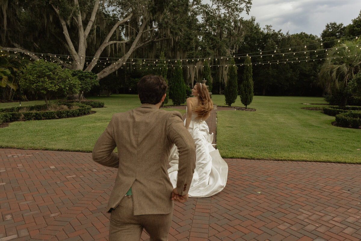 Romantic backyard wedding at The Palm Mansion in Umatilla, Florida with lush palm trees and floral arch