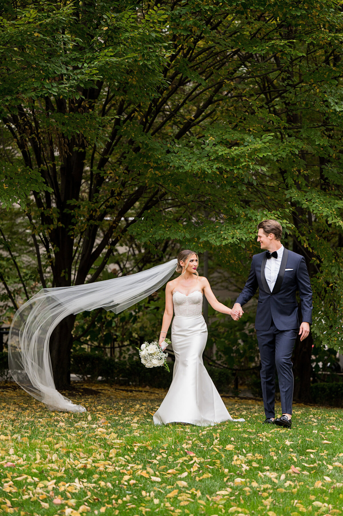 wedding veil blowing in the wind for candid wedding photo at mellon green downtown pittsburgh