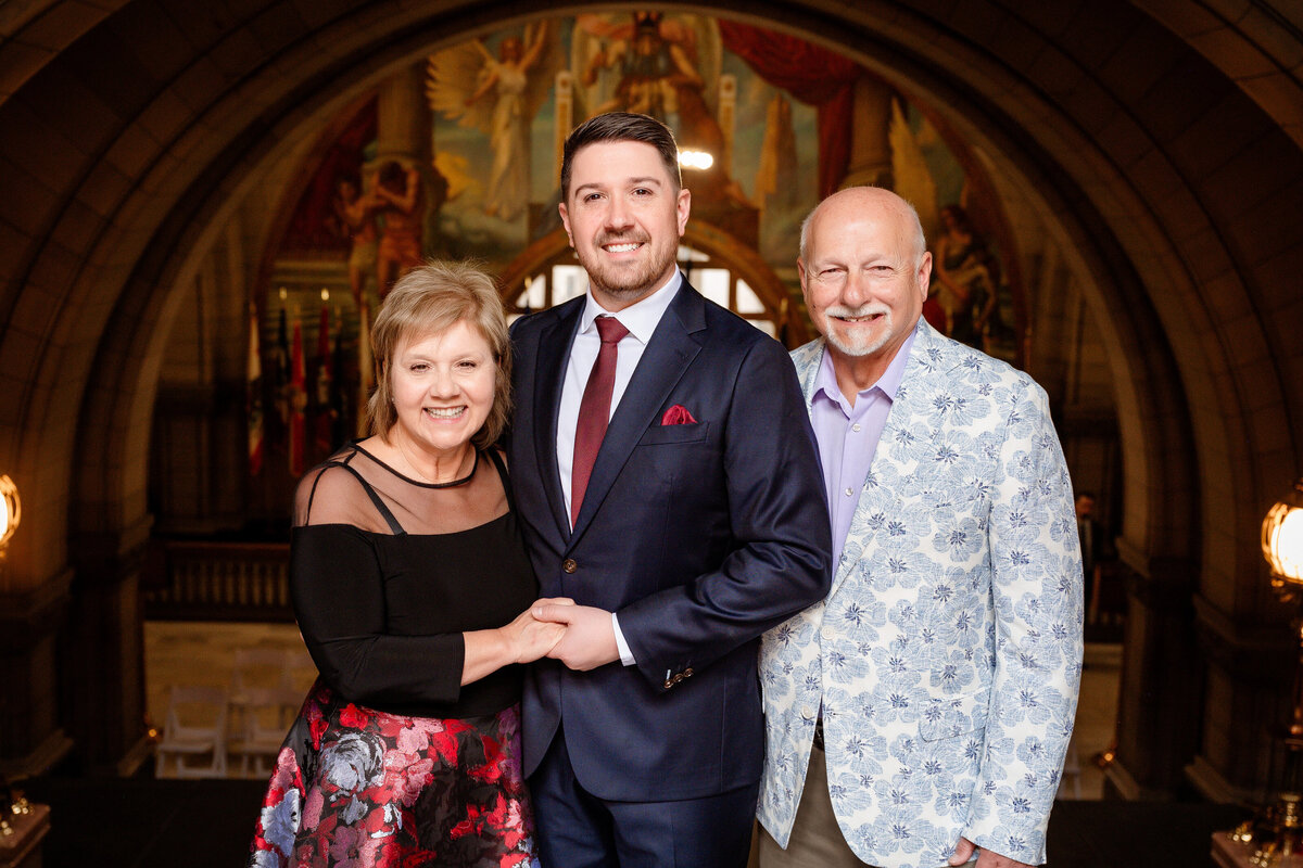 groom with parents after wedding at allegheny county courthouse
