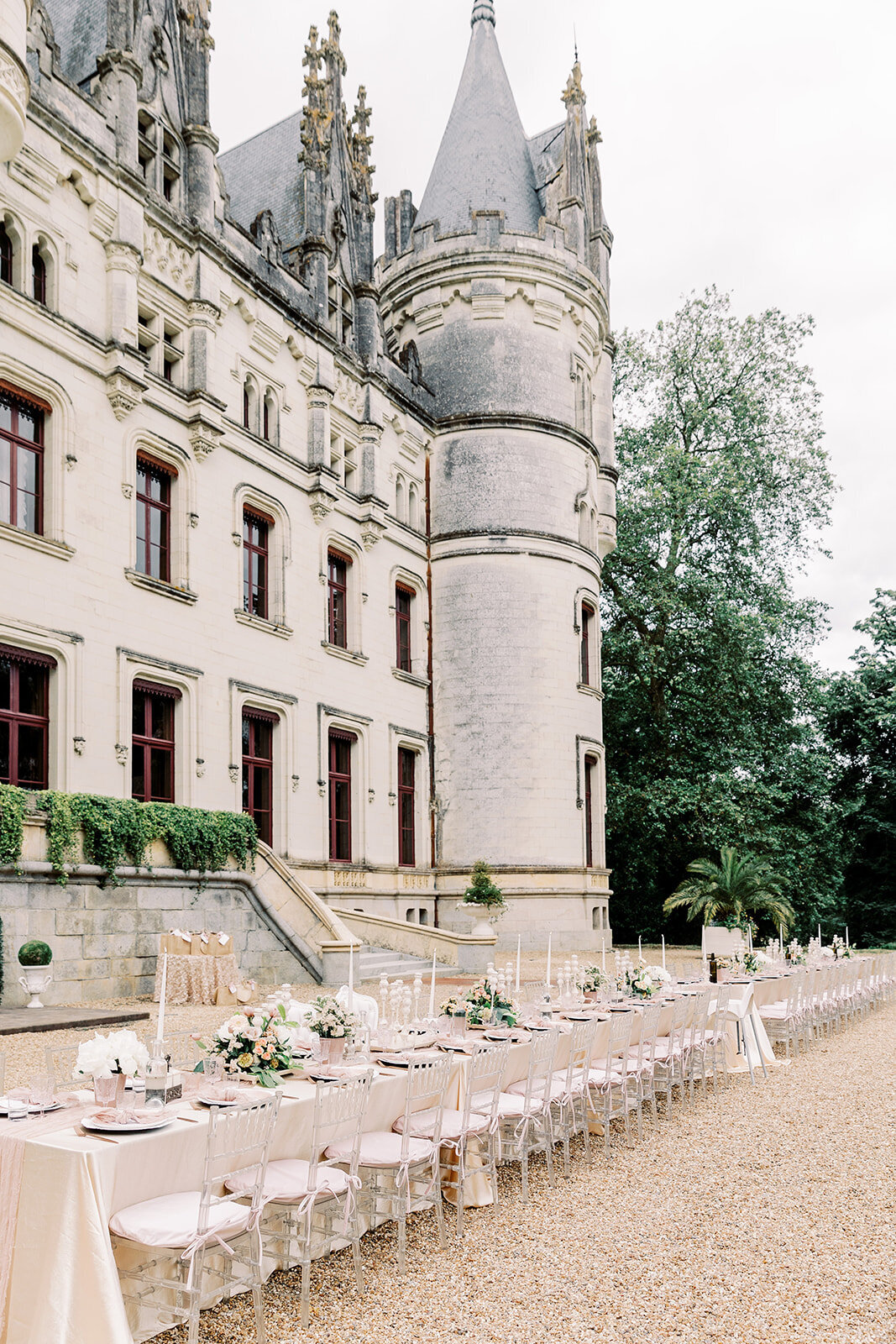 Summer outdoor table setup for a pre-wedding welcome party at Château Challain, captured in elegant, romantic fine-art wedding photography