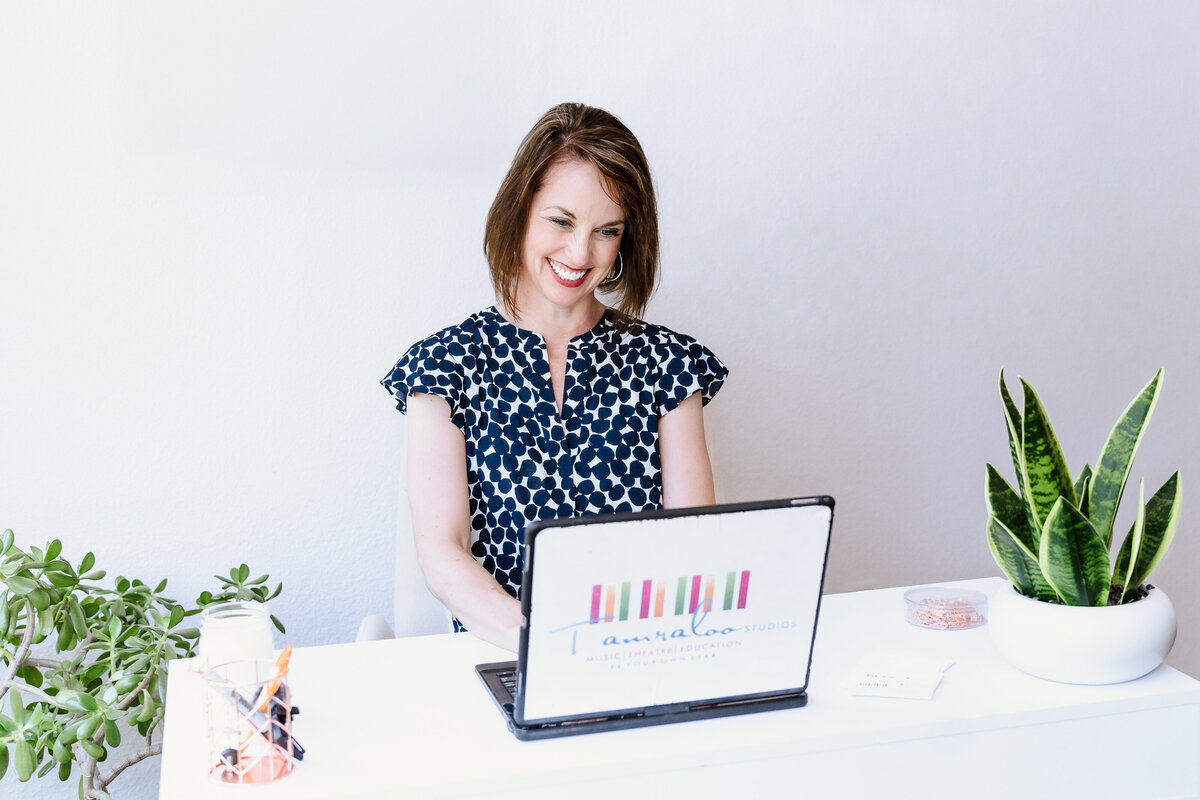 entrepreneur in the laptop of her music studios