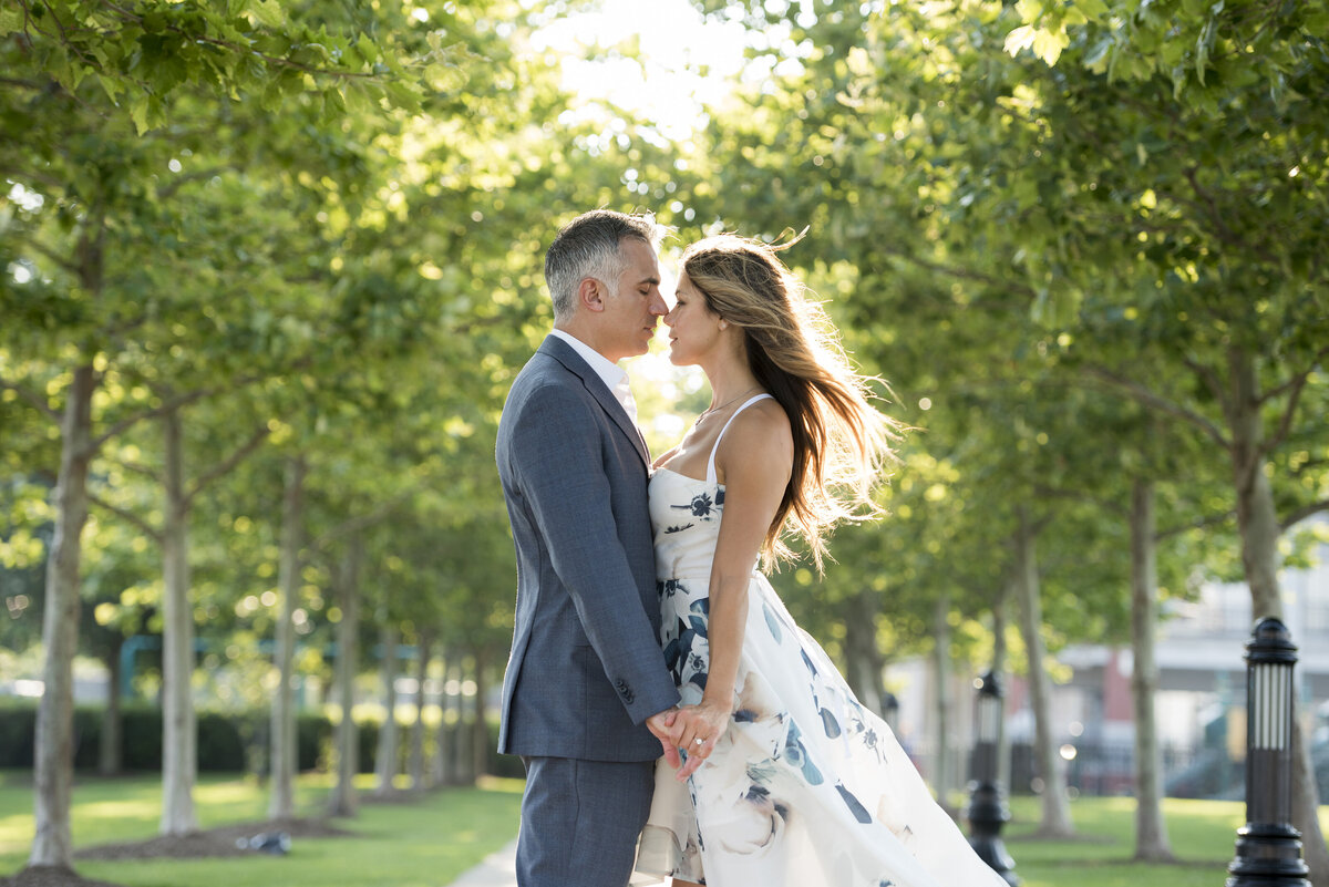 A couple holding hands and about to kiss. 