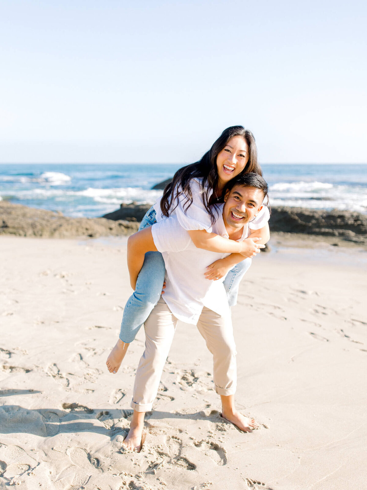 couple piggyback photo on beach