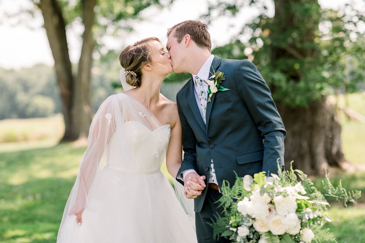 newlywed couple sharing a kiss north carolina wedding photographer
