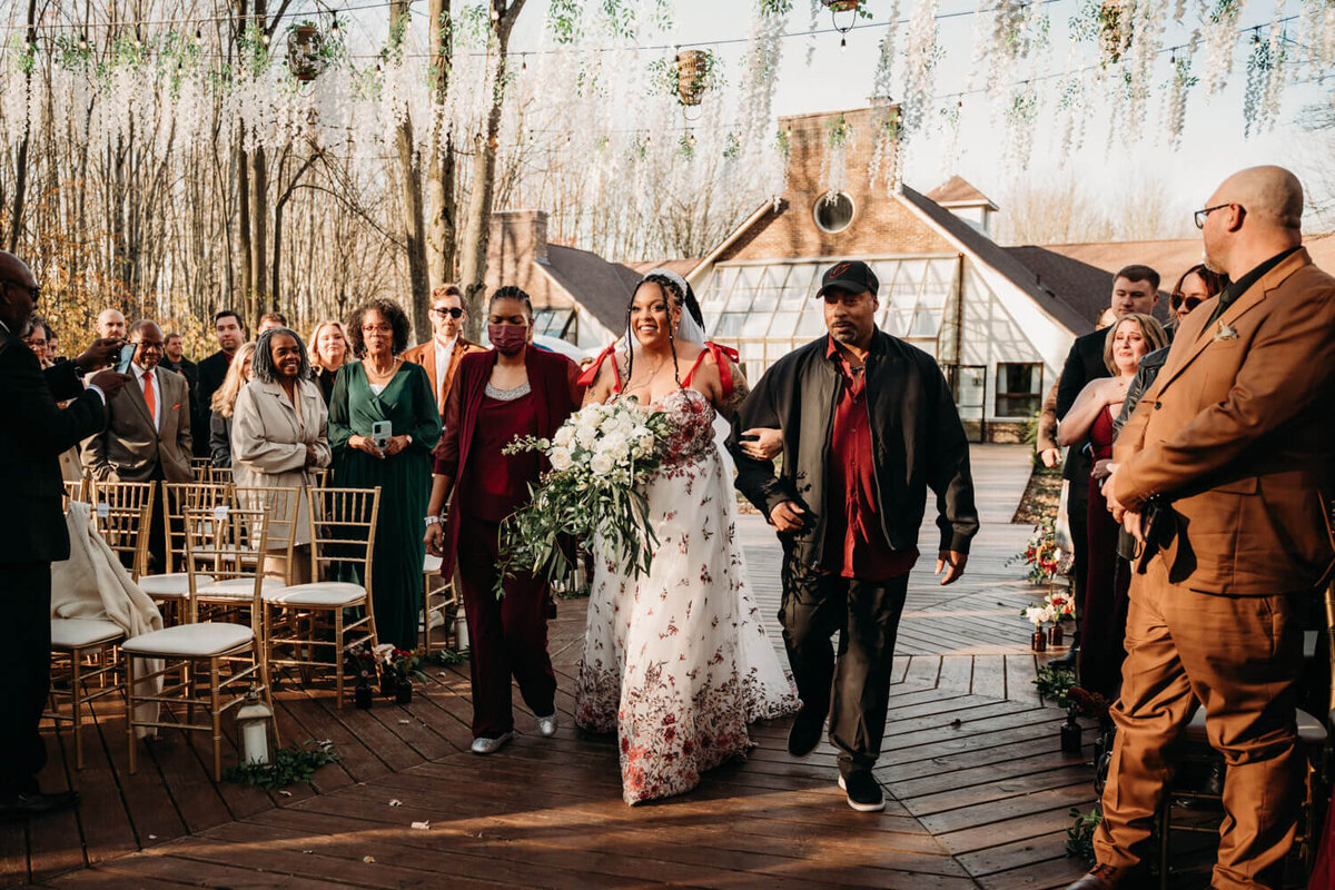 Trayce walks down aisle with two parents in Fall wedding