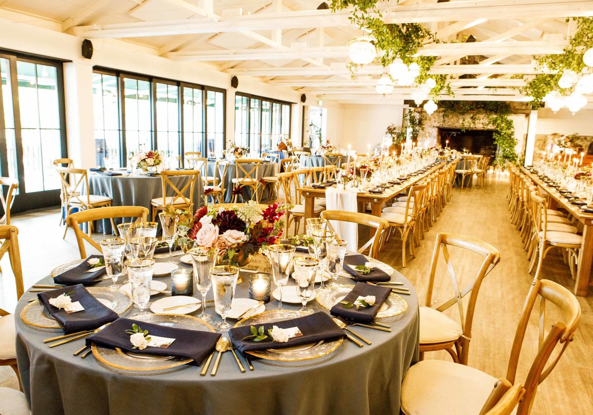 Fall wedding at Roche Harbor Resort with round and rectangular tables, vineyard chairs, and crystal chandeliers