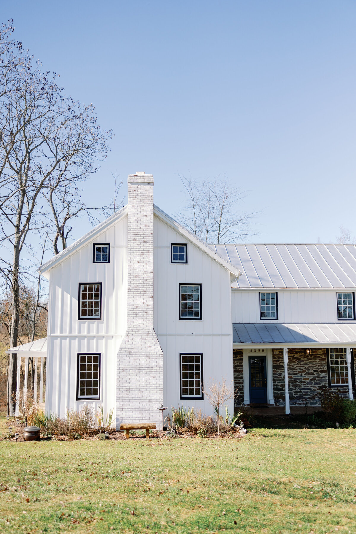 Exterior of The Hummingbird Chateau, a historic white farmhouse wedding venue in Manchester, Maryland.