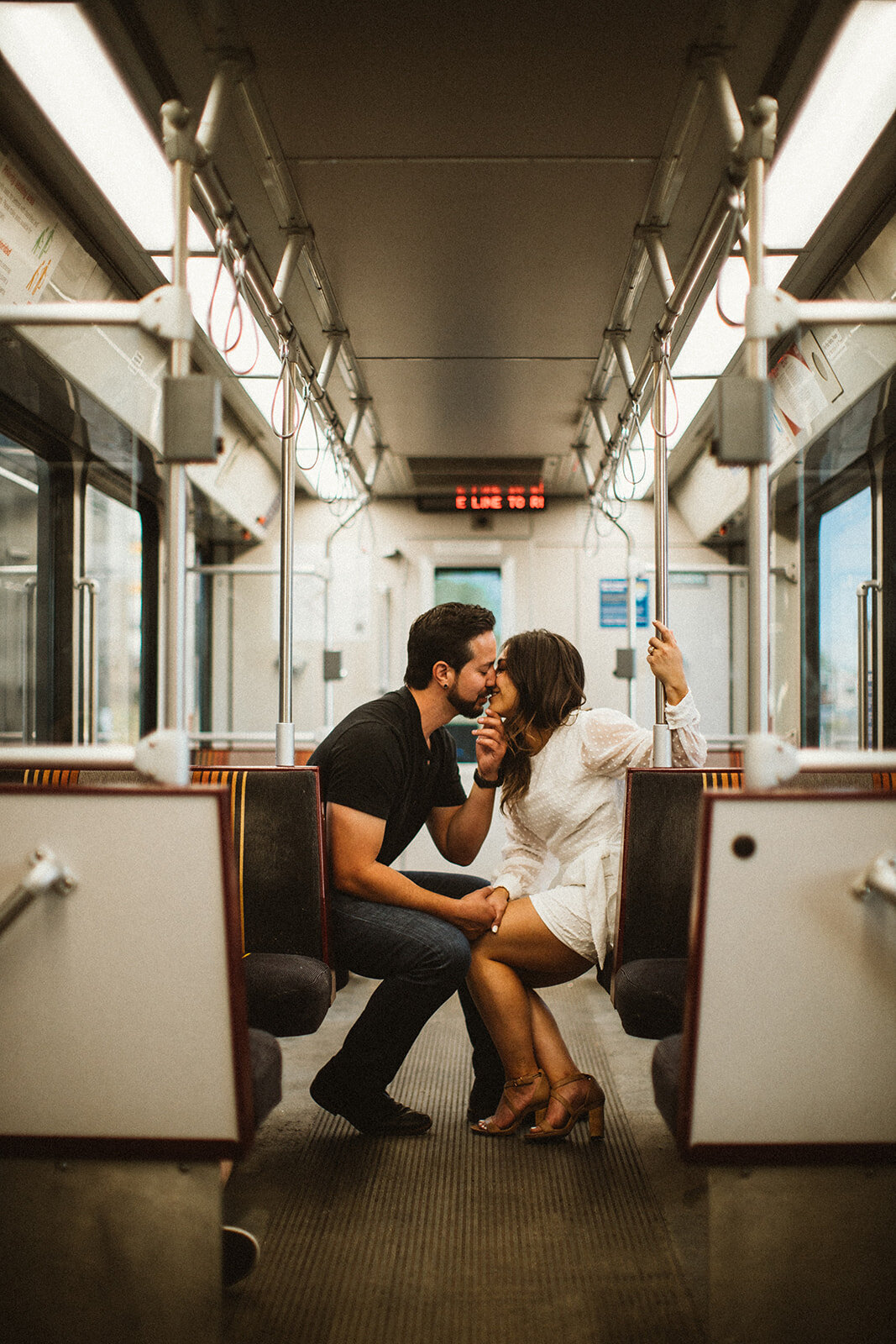 man and woman kiss on train in union station colorado